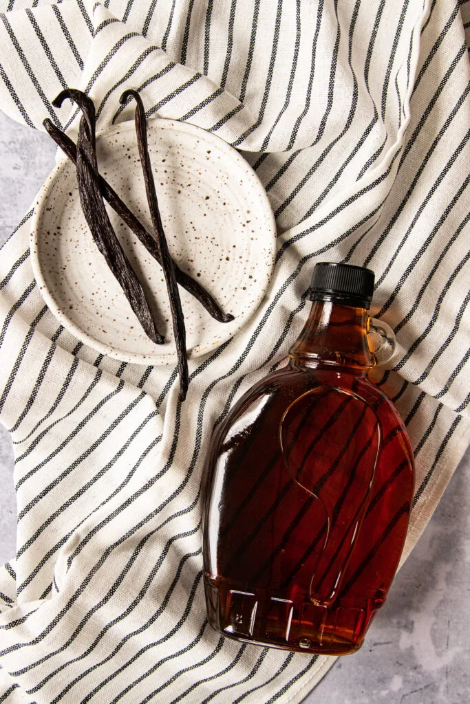 The ingredients needed- whole vanilla beans, and a bottle of maple syrup.