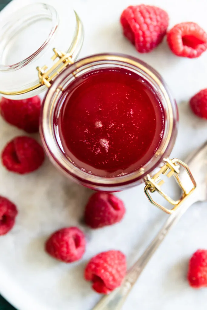 Looking down into a jar of raspberry simple syrup.