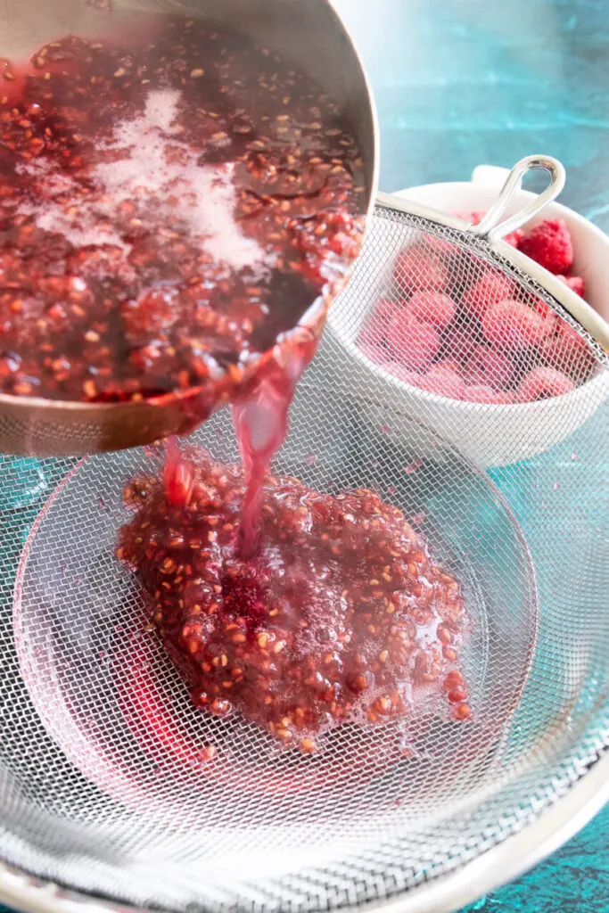 After cooking, strain the raspberry syrup with a mesh sieve.
