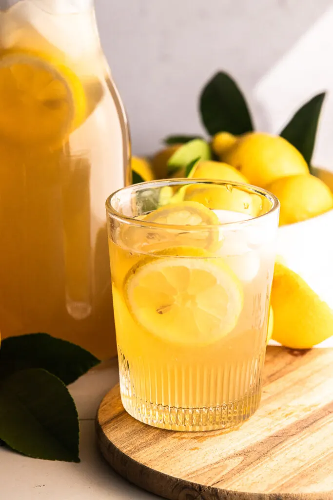 A glass of brown sugar lemonade, garnished with lemon slices.