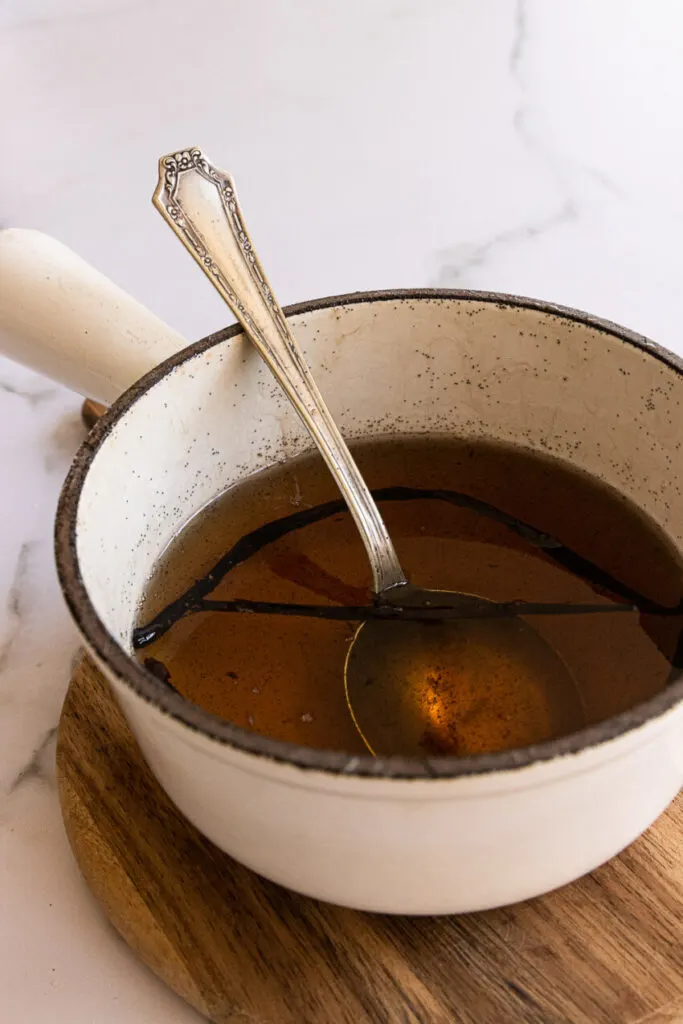 Vanilla bean simple syrup in a small pot.