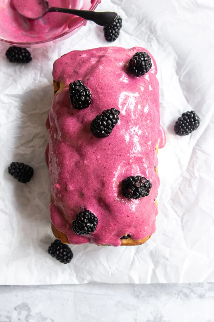 Blackberry Loaf Cake, topped with blackberry glaze and fresh blackberries.