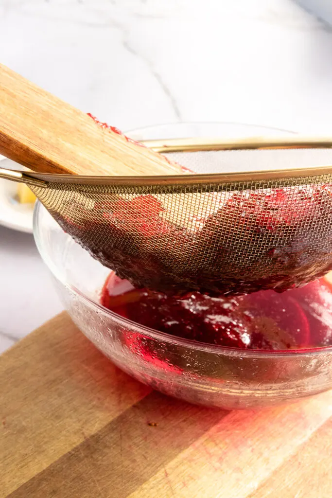 Press the cooked cranberries through a sieve, making sure to scrape of any pulp on the bottom of it in to the bowl.