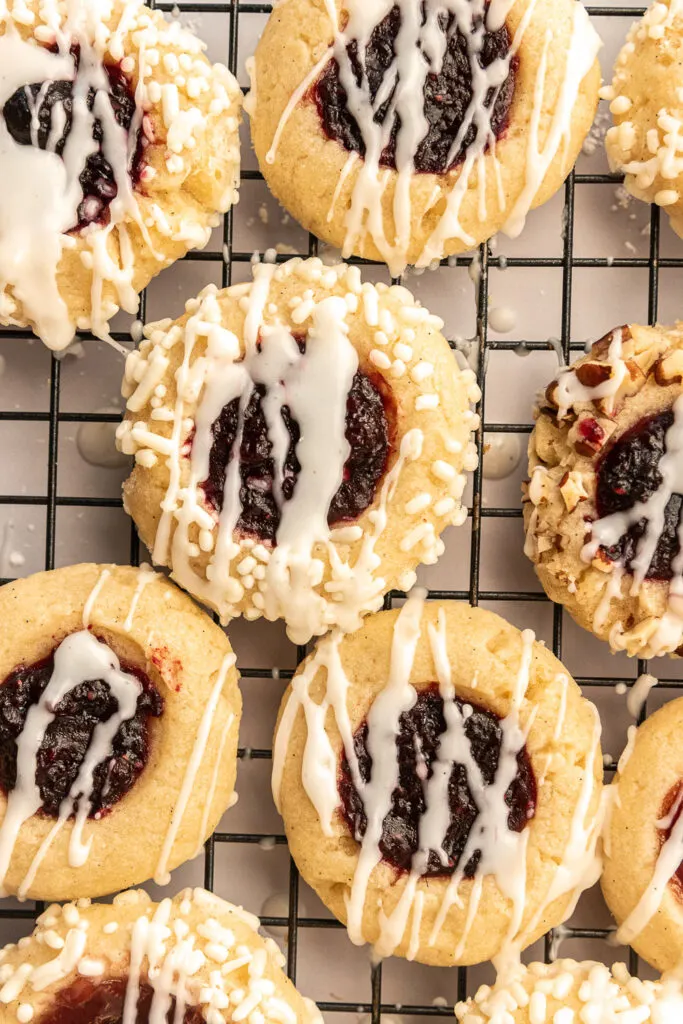 Filled and iced thumbprint cookies.