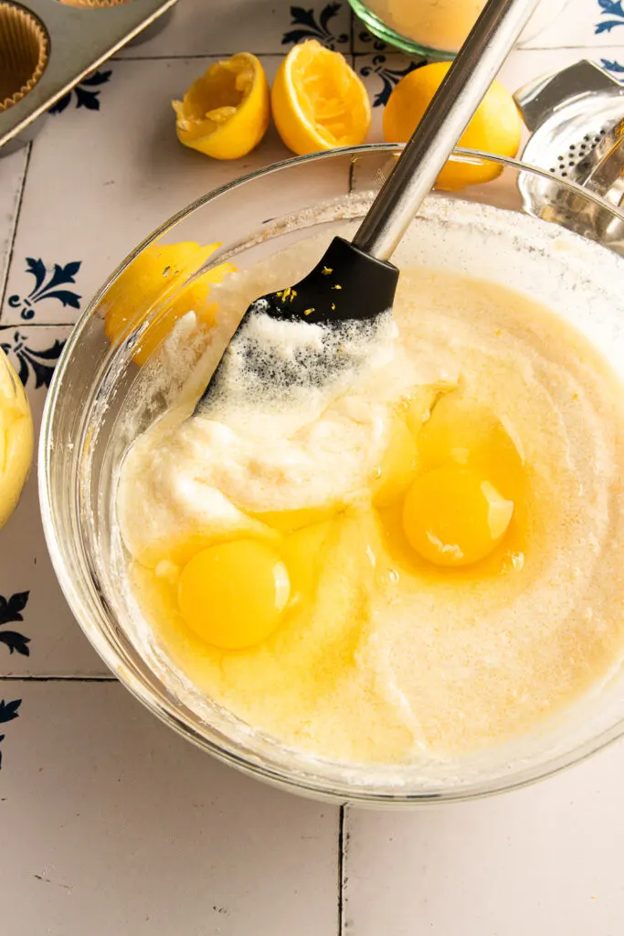 Mixing the eggs into the batter.