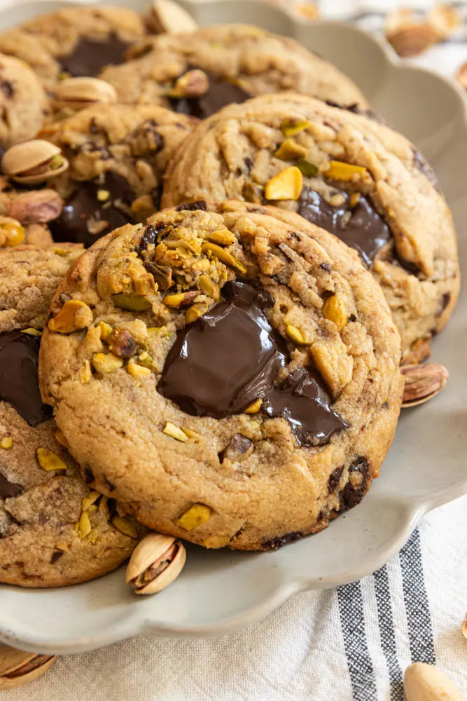 Chocolate chip pistachio cookies on a plate.