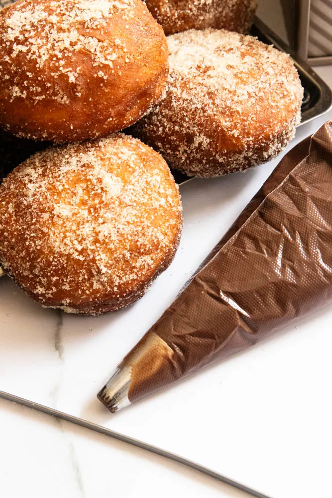 The donut cream filling in a piping bag, ready to fill the donuts.