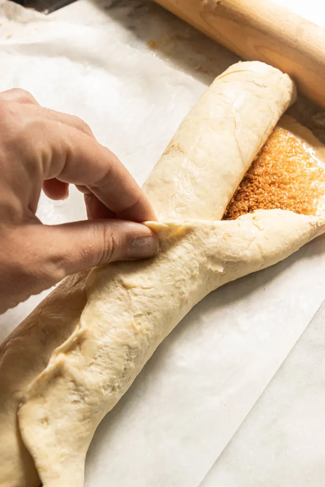 Pinching the dough closed.