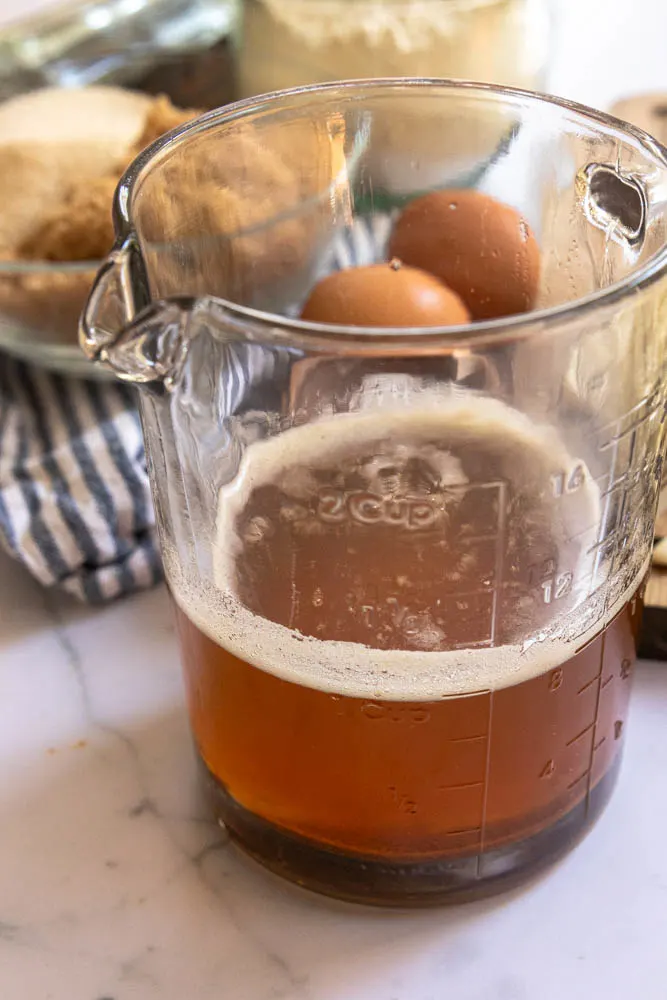 Brown butter in a glass measuring cup.