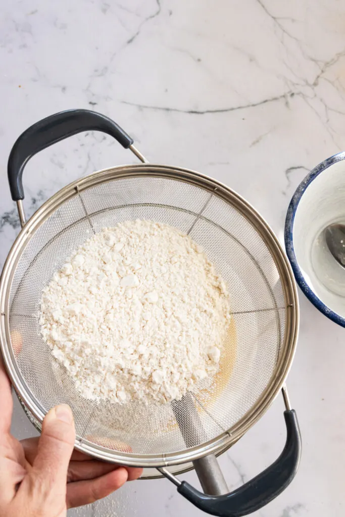 Sifting the dry ingredients into the wet.