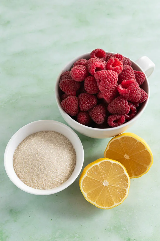 The ingredients or raspberry coulis--raspberries, lemon, and sugar.