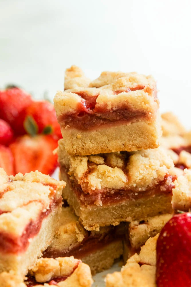 A stack of strawberry shortbread bars.