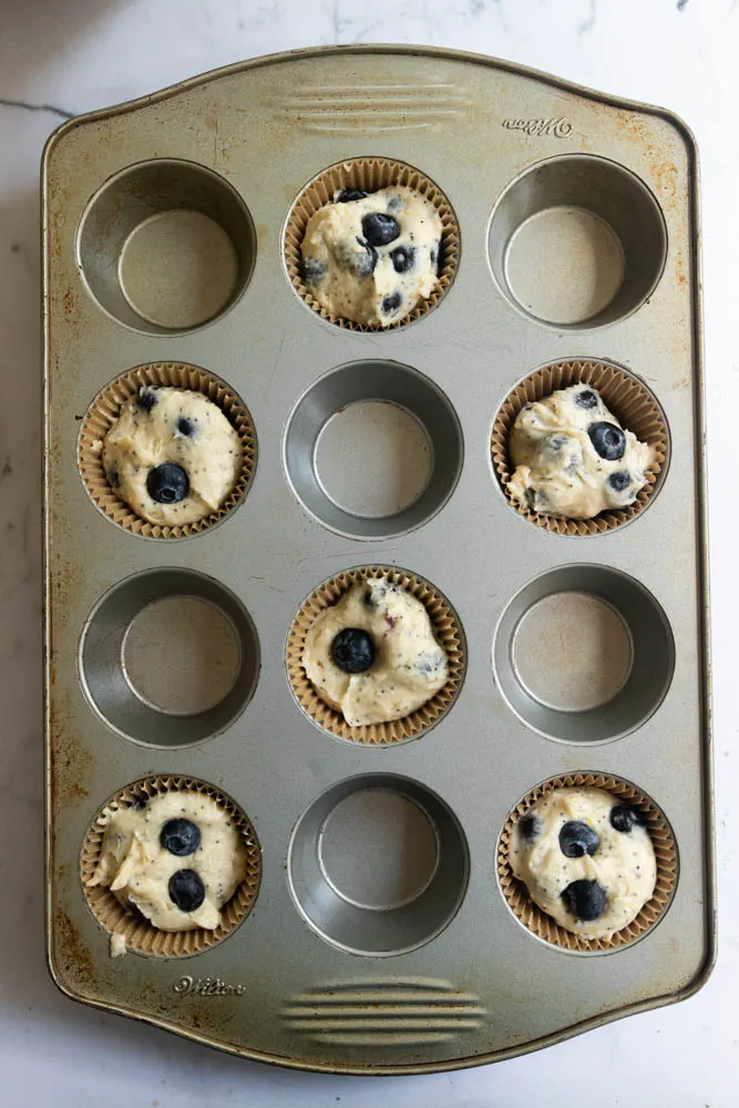 Muffin tins filled with batter and ready to bake.